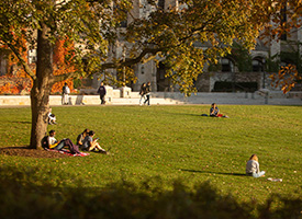 Students on campus looking at various hand=held devices