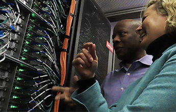 Research Computing staff looking at a server in data center