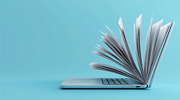 Laptop with pages turning into a book