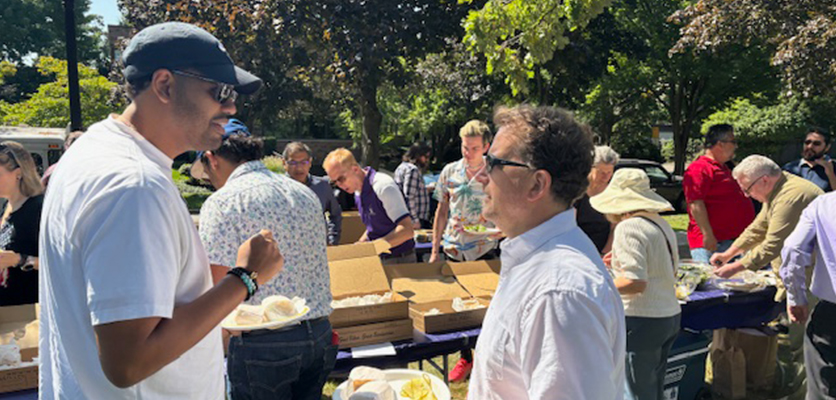 Omar Negron, systems administrator, and Scott Terry, manager of endpoint device management and support, catch up at the summer picnic.