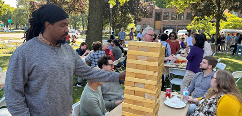 Jenga has become a go-to game at the annual picnic. Craig Stevens, innovator in residence, gets the game started.