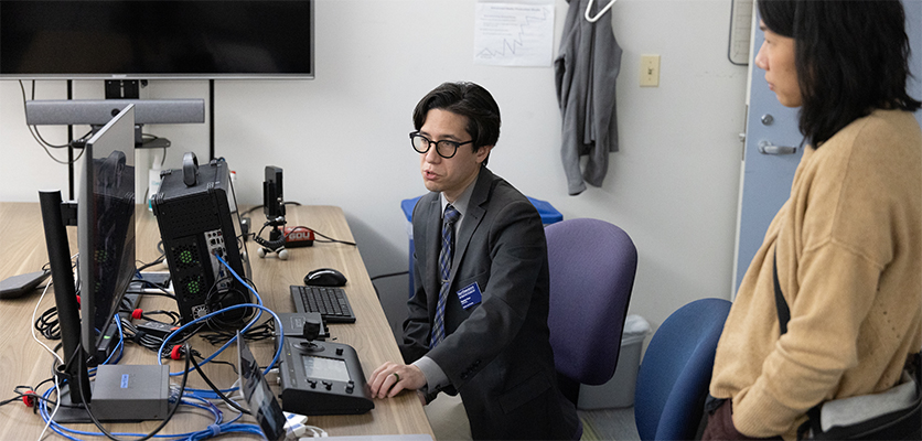 Stephen Poon, digital media specialist video lead, talks with an attendee about the team’s Pan-Tilt-Zoom camera capabilities. 