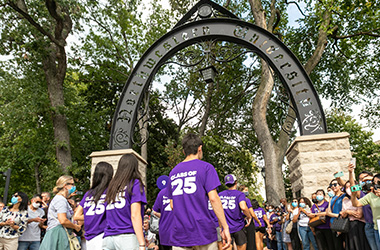Northwestern students walking through the arch