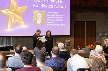 Tobin receives her Employee Excellence Award from Sean Reynolds
