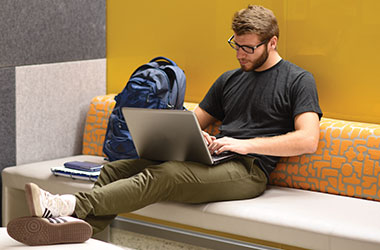 Student working on laptop in Kresge Hall