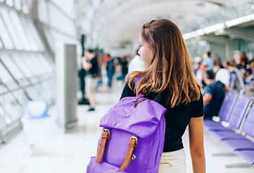 woman walking to an airport gate waiting area