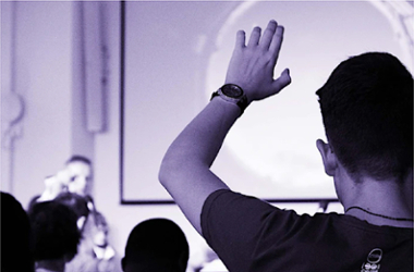 Photo by Felicia Buitenwerf on Unsplash/Student raising their hand during a workshop