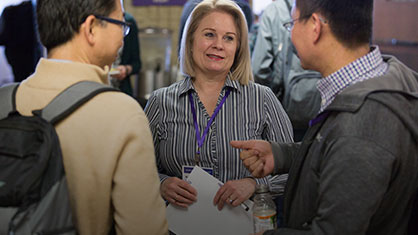 RuthAnn Ostrowski, Director of Cyber Service Operations, IT Cyber Service Operations talking to colleagues after extended staff meeting