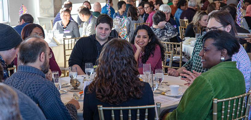 Northwestern IT staff gather at the Halim Time & Glass Museum in Evanston for the organization's annual winter celebration.