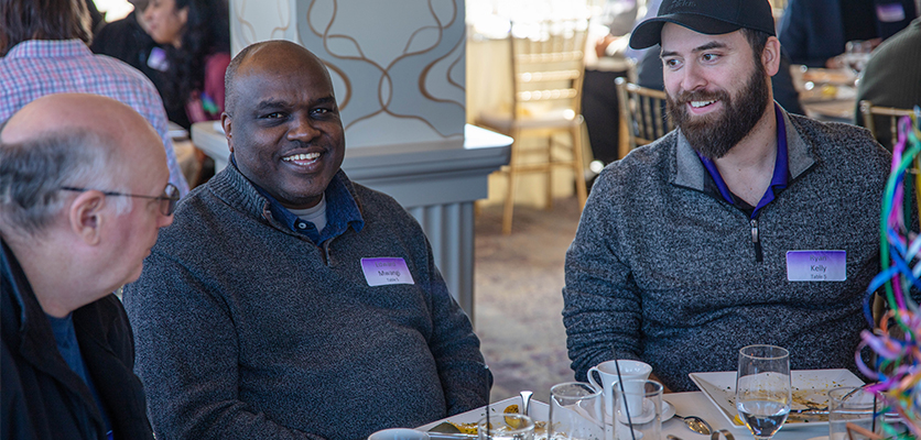 Northwestern IT staff gather at the Halim Time & Glass Museum in Evanston for the organization's annual winter celebration.