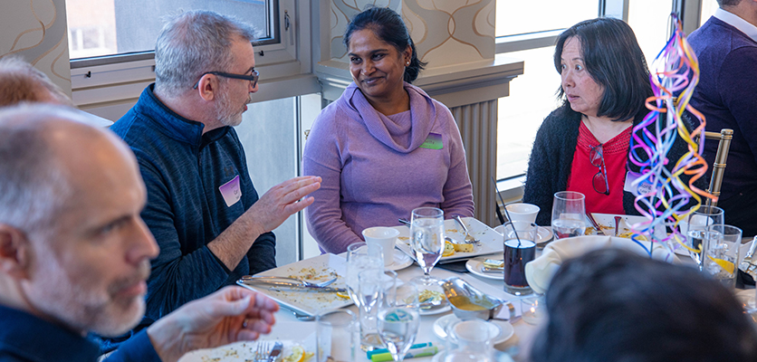 Northwestern IT staff gather at the Halim Time & Glass Museum in Evanston for the organization's annual winter celebration.