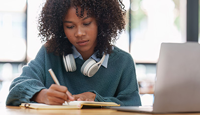 Young woman university student learning online using laptop computer.