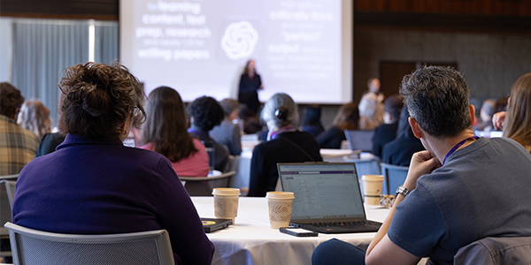 Attendees listen to the TEACHx keynote speaker in a packed Louis Room
